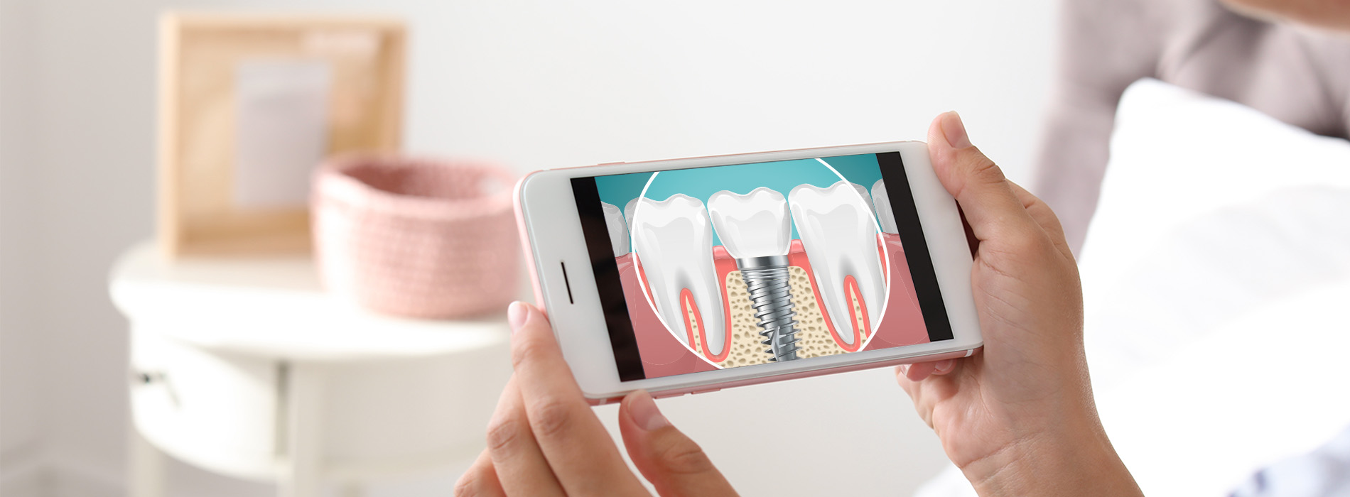 A person holding a smartphone with a zoomed-in picture of a tooth on its screen.